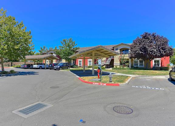 A sunny day at a residential area with houses and cars at Hurley Creek Apartment Homes, California, 95834