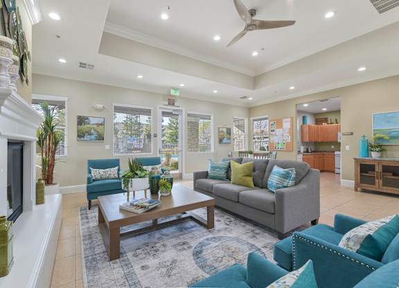 Community clubhouse with modern furniture and fireplace at Corsair Park Senior Apartments, North Highlands, California