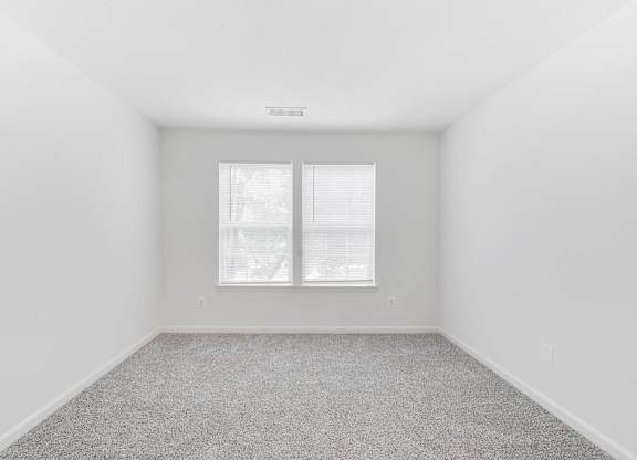 Empty bedroom with carpet and window at Acclaim at Ashburn Apartments, Ashburn, 20147