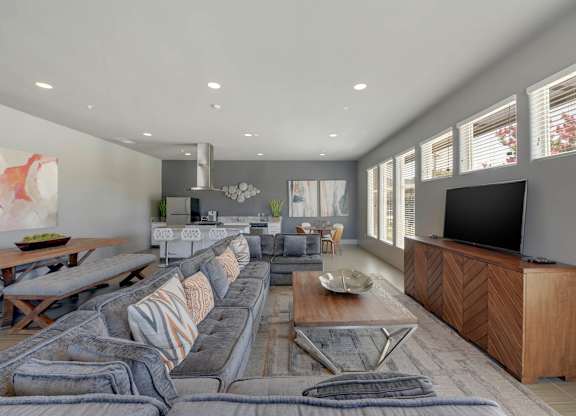 Modern open concept living space with sectional sofa at Anton Arcade Apartments, Sacramento, CA