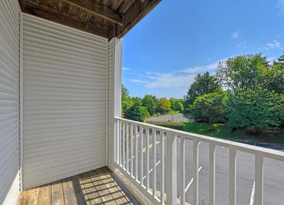 A balcony with a view of a road and trees at Acclaim at Sterling, Sterling, VA