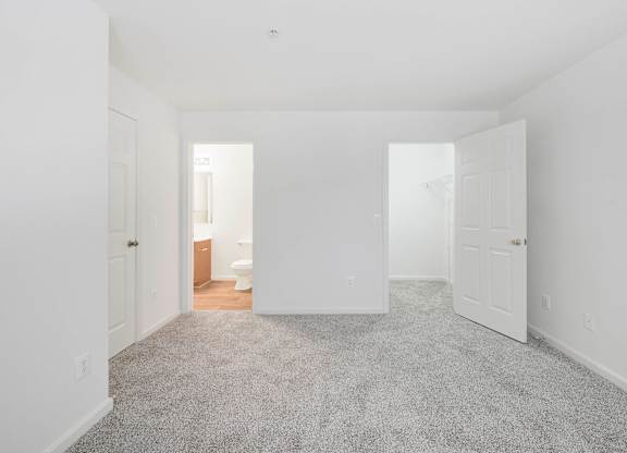 Empty bedroom with carpet and closet at Acclaim at Ashburn Apartments, Ashburn, Virginia
