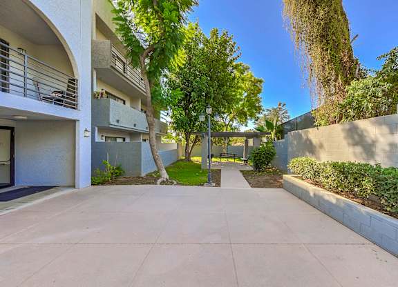 A sunny day in a residential area with a clear blue sky.