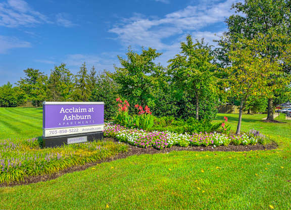 Property entrance sign with colorful flower landscaping at Acclaim at Ashburn Apartments, Virginia, 20147
