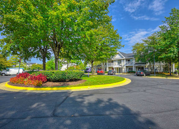 Landscaped traffic circle with apartment buildings at Acclaim at Ashburn Apartments, Ashburn, VA 20147