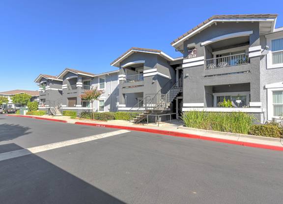 A row of modern houses with a clear blue sky above.