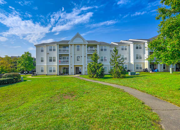Apartment buildings with green lawn at Acclaim at Ashburn Apartments, Ashburn, Virginia