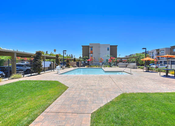 Resort style swimming pool with sun deck at Anton Arcade Apartments, California