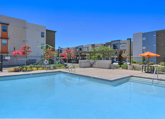 Resort style swimming pool with spa and seating area at Anton Arcade Apartments, California, 95825