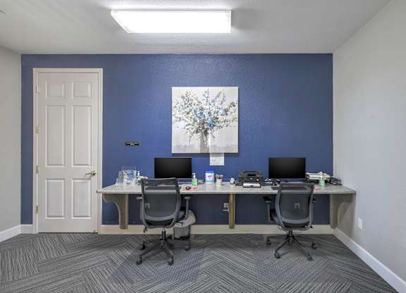 A room with two desks and two chairs at Hurley Creek Apartment Homes, Sacramento