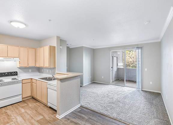 A kitchen with white appliances and wooden cabinets.