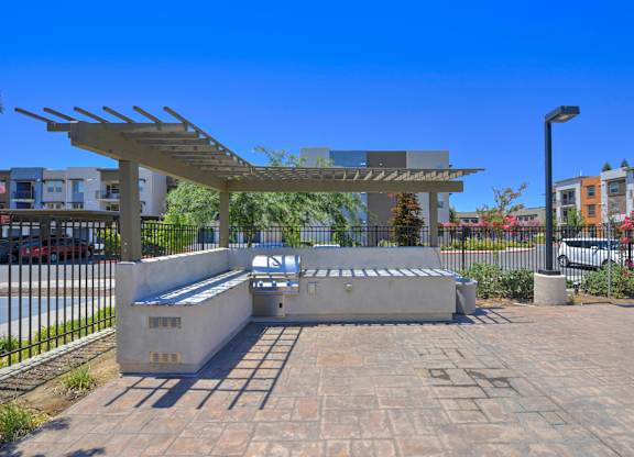 Outdoor barbecue area with covered pergola at Anton Arcade Apartments, Sacramento, CA