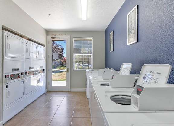 A row of washing machines in a laundromat at Hurley Creek Apartment Homes, California
