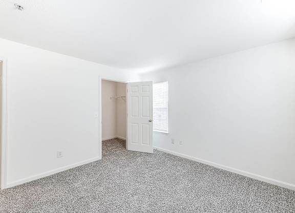 A room with a carpeted floor and a ceiling fan at Acclaim at Sterling in Sterling, VA