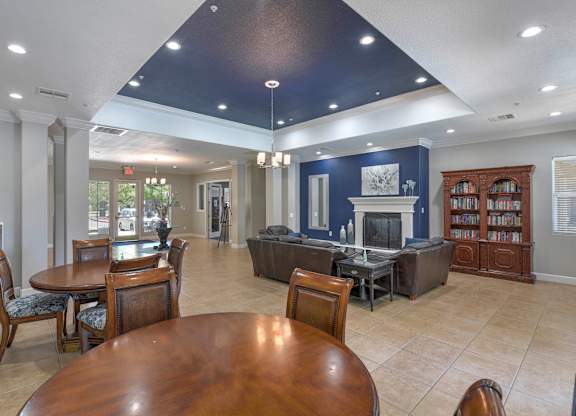 A large room with a fireplace and a bookcase at Hurley Creek Apartment Homes, Sacramento, CA