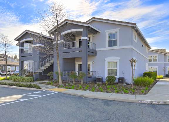 Two story apartment buildings with exterior stairs at Corsair Park Senior Apartments, California