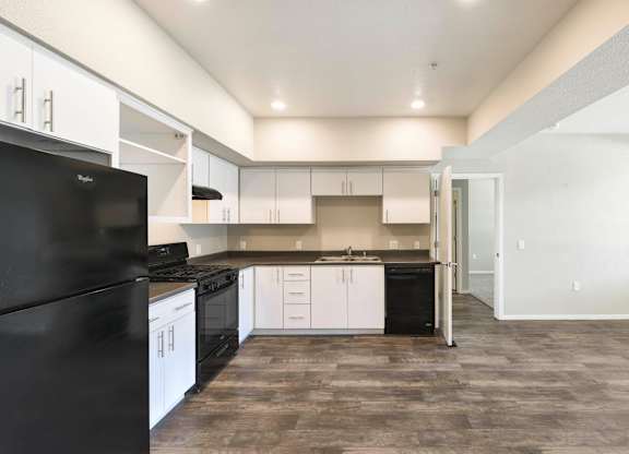 Modern l shaped kitchen with white cabinets at Anton Arcade Apartments, Sacramento, CA 95825