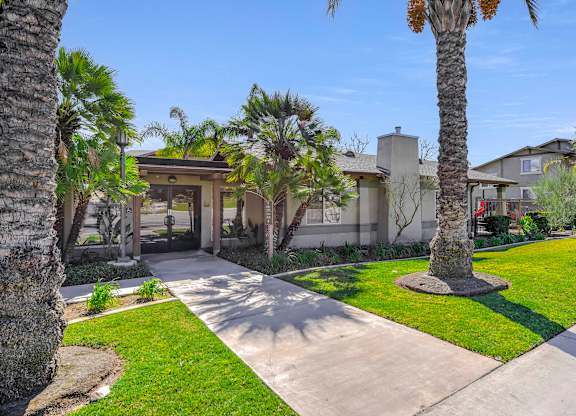 A house with a palm tree in front at Yorba Linda Apartments, Yorba Linda, CA