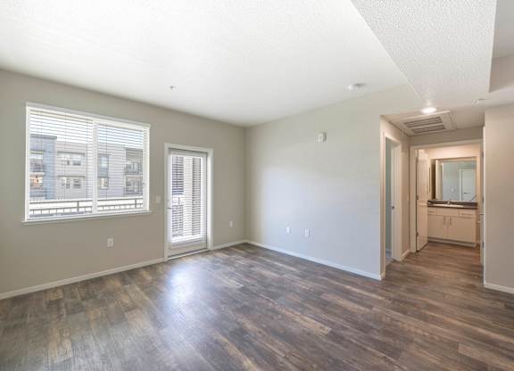 Spacious bedroom with hardwood floors and balcony access at Anton Arcade Apartments, Sacramento, 95825
