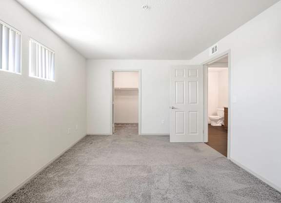 A room with a carpeted floor and a white door at Hurley Creek Apartment Homes, Sacramento, California
