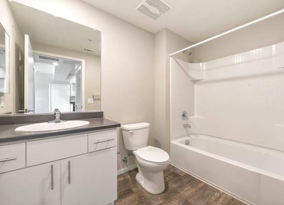Modern bathroom with white vanity and shower at Anton Arcade Apartments, Sacramento