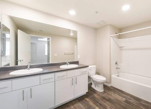 Spacious bathroom with dual sinks and soaking tub at Anton Arcade Apartments, California, 95825