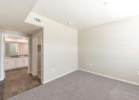 Empty bedroom with carpet and adjacent bathroom at Anton Arcade Apartments, Sacramento, CA 95825