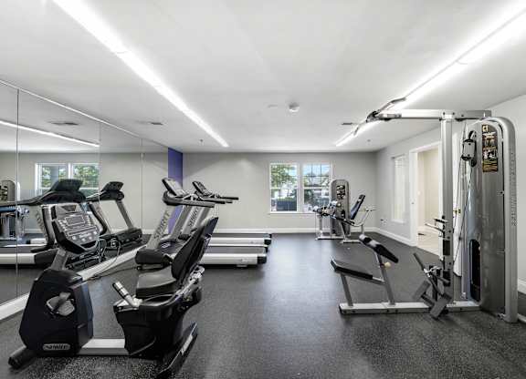 A gym with treadmills, exercise bikes, and other equipment at Acclaim at Sterling, Sterling 20164