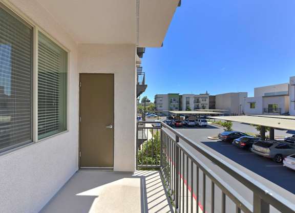 Private balcony with metal railing and door at Anton Arcade Apartments, Sacramento, CA