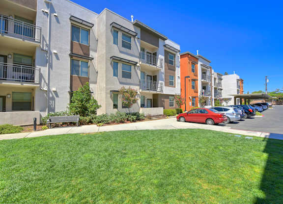 Modern apartment complex with parking and landscaping at Anton Arcade Apartments, Sacramento