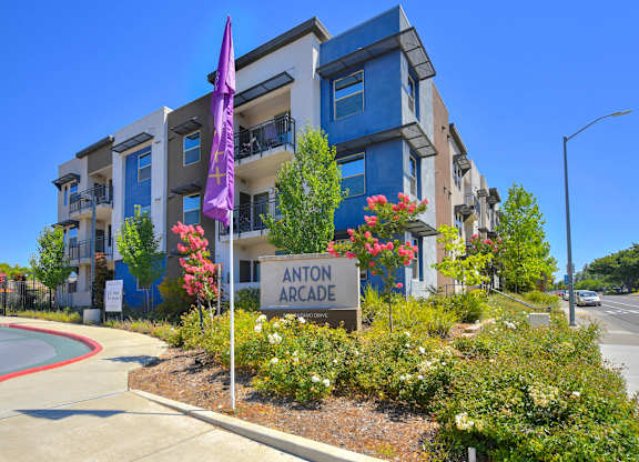 Modern apartment building exterior with landscaped entrance at Anton Arcade Apartments, California