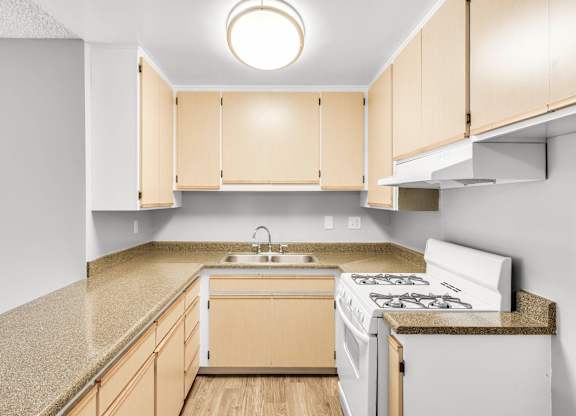 Kitchen with a White Stove at Northpointe Apartments, Long Beach, CA