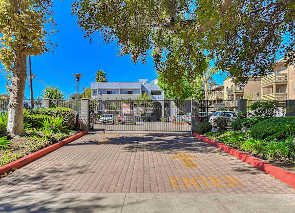 A gated entrance with the word "ENTER" painted on the pavement.