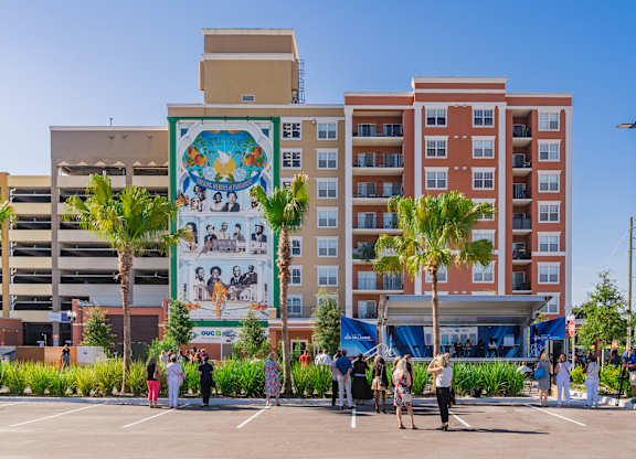 A mural on a building with a crowd of people in front of it. at City View, Orlando, Florida