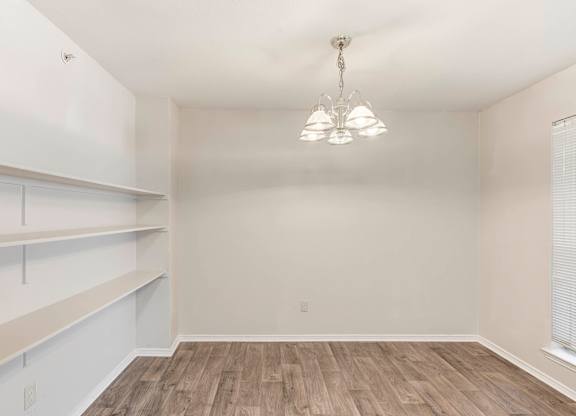 A room with a chandelier and wooden flooring. at Cooper's Crossing, Texas