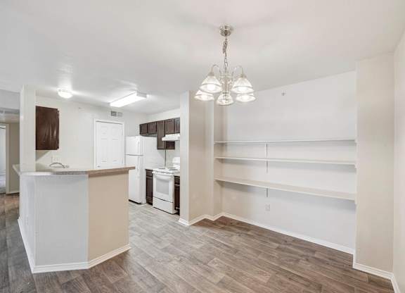 A kitchen with a white counter and a white fridge. at Cooper's Crossing, Irving, 75038