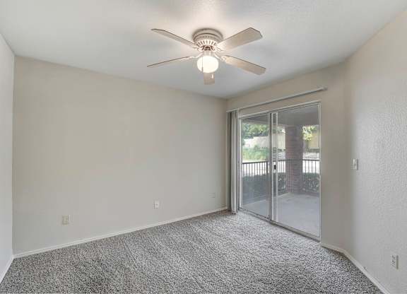 A room with a ceiling fan and carpeted floor. at Cooper's Crossing, Irving, TX, 75038