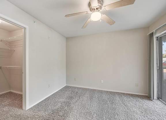 A room with a ceiling fan and carpeted floor. at Cooper's Crossing, Texas