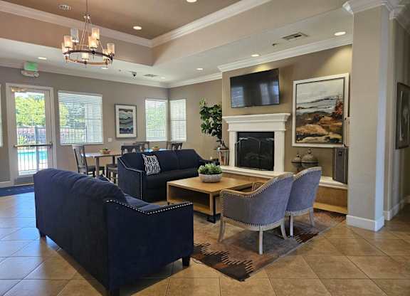 A living room with a fireplace and a television.