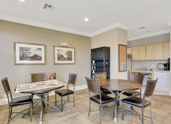 Community dining area with kitchen and seating at Lincoln Creek Apartments, California
