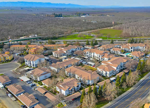 Aerial view of apartment community with red tile roofs at Lincoln Creek Apartments, Dixon, California