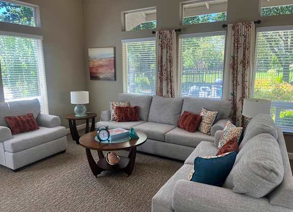 A living room with grey couches and a coffee table.