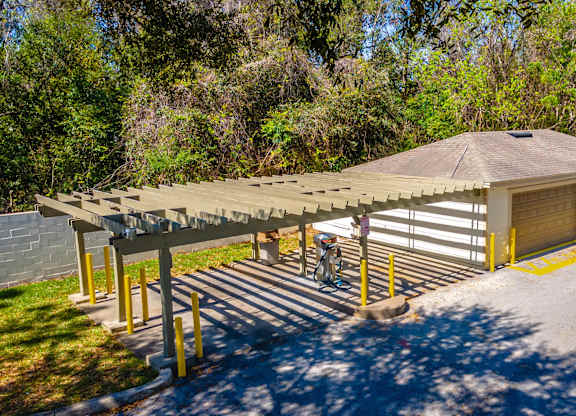 A covered walkway leads to a garage door at Retreat at Valencia Apartment Homes, Orlando, 32825