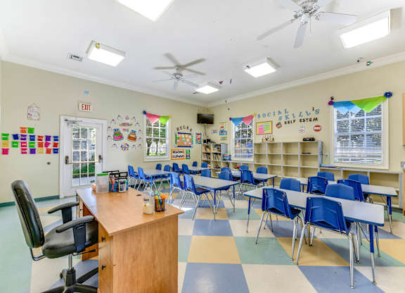 Classroom with a desk, chairs, and a whiteboard at Saxon Trace, Orange City
