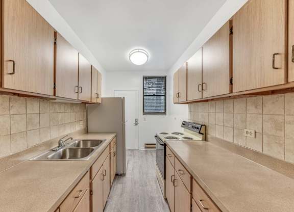 Kitchen with Wooden Cabinets at Scotland Yard Apartments, Chicago, IL