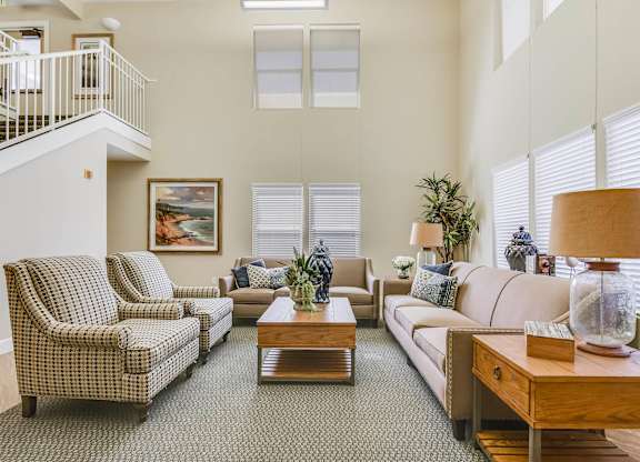 A living room with a couch, chairs, and a coffee table.