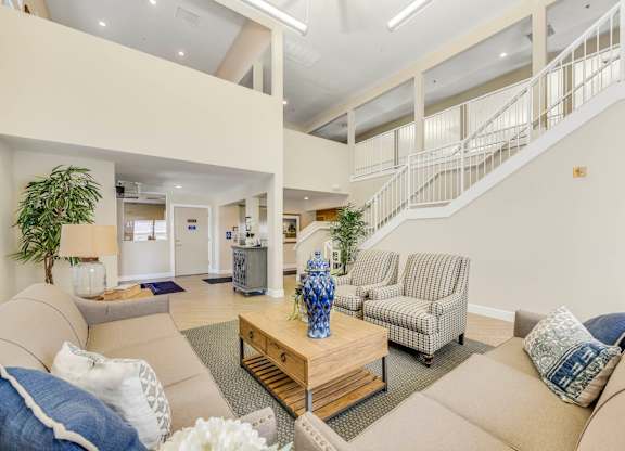 A living room with a staircase in the background.