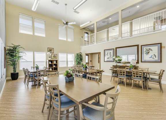 A dining room with a long table and chairs.