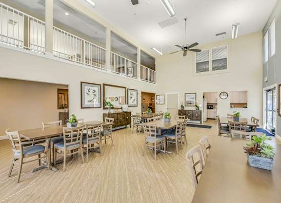 A spacious dining room with a long table and chairs.