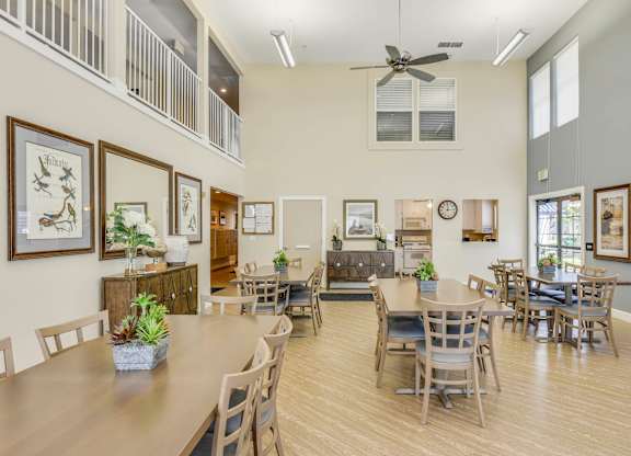 A dining room with a wooden table and chairs.
